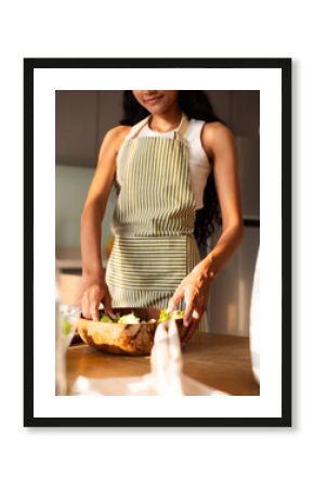Woman Preparing Fresh Salad in a Modern Kitchen Setting