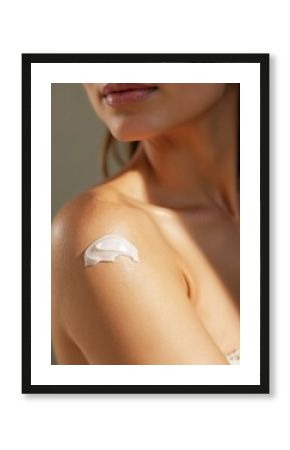 Close-up of woman shoulder with white moisturizing cream. Wet skin with lotion for hydration. Beauty care, wellness, body treatment for perfect female skin. Spa, sensuality, relaxation. Beautiful