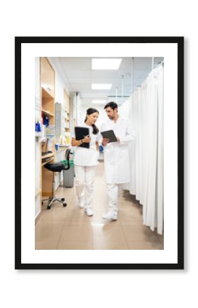 Medical professionals reviewing patient data while walking in hospital