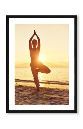 Female doing yoga on calm exotic beach