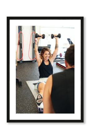 Sportswoman with dumbbells.