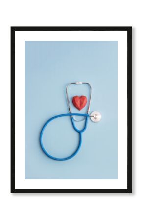 Stethoscope and red polygonal heart on blue background. Vertical banner for medical clinic or center, copy space