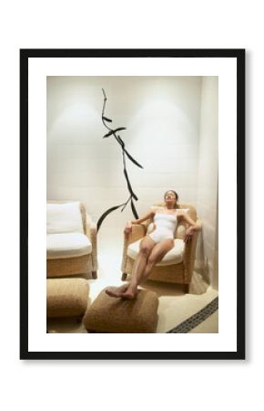 Woman relaxing in chair in luxury spa waiting room