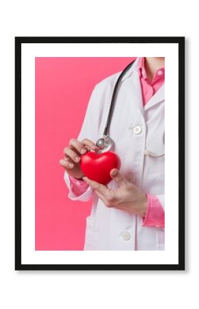 Doctor holding a red heart with stethoscope.