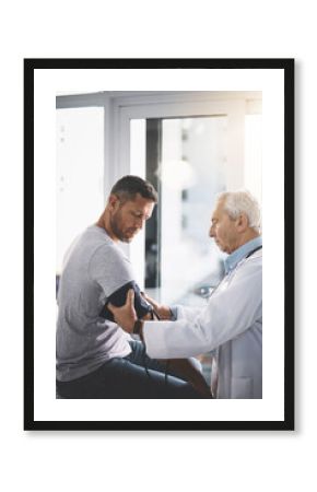Medical, doctor and patient or man for blood pressure in healthcare with test for hypertension and wellness check. Health professional, person and consultation to monitor vital signs with assessment