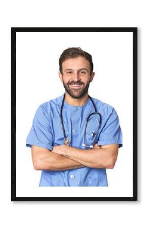 Hispanic male nurse in studio laughing and having fun.