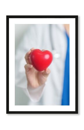 Doctor hand holding red heart shape in hospital. love, donor, world heart day, world health day, CSR donation and Insurance concepts