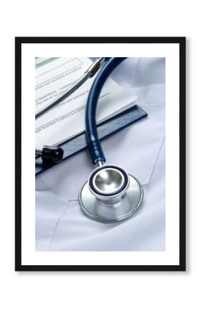 A stethoscope  and a clipboard on a medical uniform, closeup