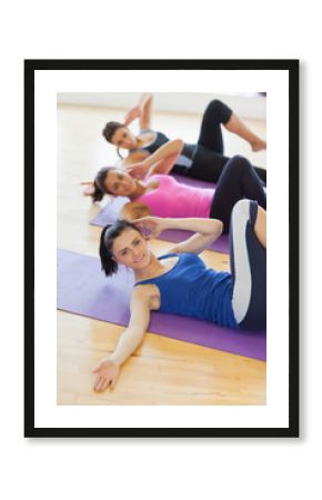 Class and instructor doing stretching pilate exercises