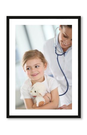 Doctor examining little girl with stethoscope