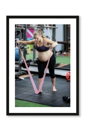 Pregnant woman exercising with resistance band