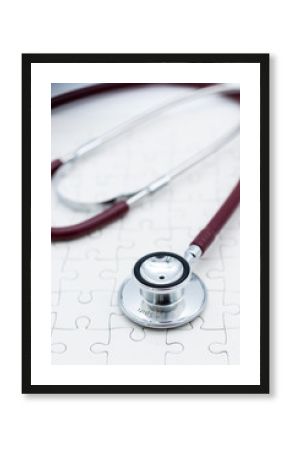 Stethoscope on jigsaw board. Image use for health medical care of family concept.