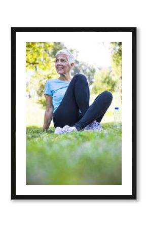 Senior woman resing after workout in park