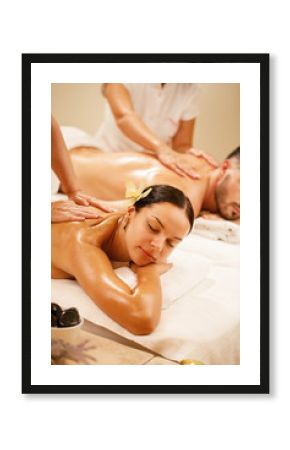 Beautiful woman and her boyfriend having back massage at the spa.