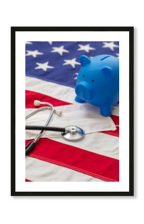 US of America health budget. Medical stethoscope, protective mask and piggy bank on a USA flag, closeup view.