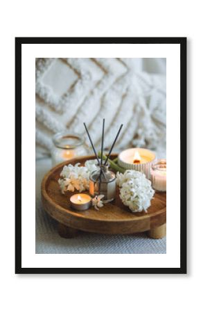 Cozy corner for home meditation and relaxation. Decor for apartment, house, indoors design. Aroma diffuser, burning scented candles, spring aromatherapy with blooming hyacinth floral scent