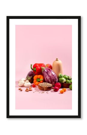 Vegan background with fresh seasonal autumn vegetables, vegan fall still life on pink