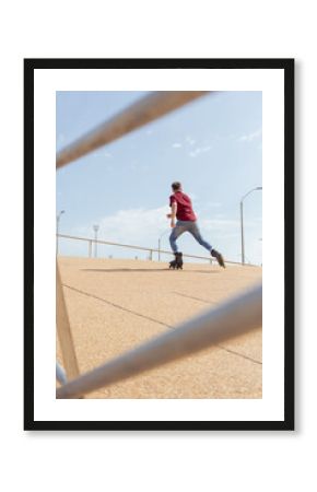 Young man skateboarding on inline skates on a sunny day