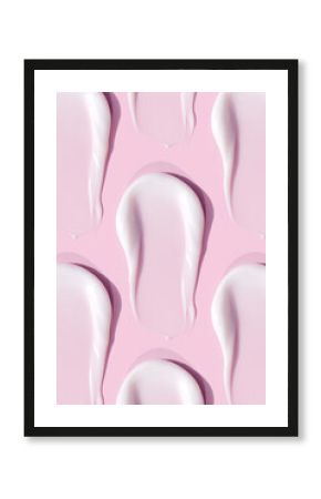smears of cream texture on pastel pink background