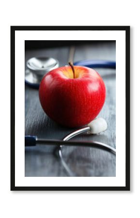 Red apple and stethoscope symbolizing health and nutrition