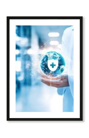 Doctor in white coat holds planet earth with digital health technology concept on blue background, digital healthcare network and first healthcare insurance