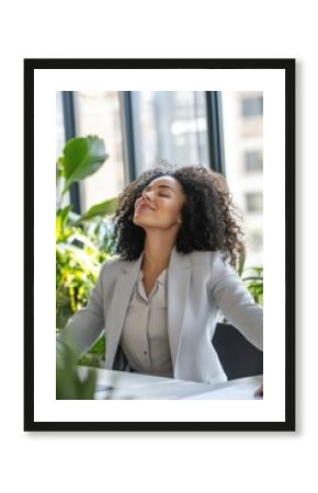 Businesswoman enjoying peace and relaxation in office with plants, practicing mindfulness and stress relief, promoting wellness and productivity in corporate workspace.