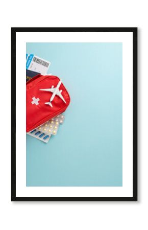Essential travel healthcare preparation featuring a red first aid kit, blister packs, patient cards, and a travel-themed vertical airplane model, perfect for safe exploration