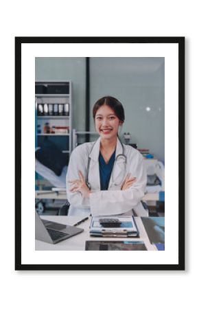Medical health clinic beautiful Asian doctor working using smart tablet touching, stethoscope diagnosing patient analysis research examination healthcare provider service insurance in modern office