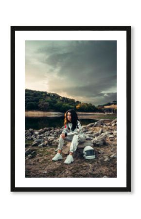 Thoughtful astronaut in space suit at beach