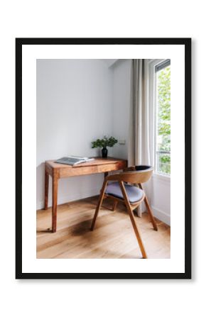 study space with wooden desk and chair, with plenty of natural light