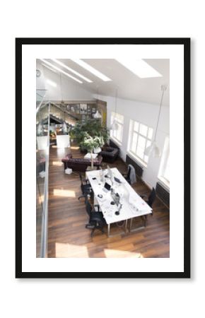 Desks with PCs in bright and modern open space office