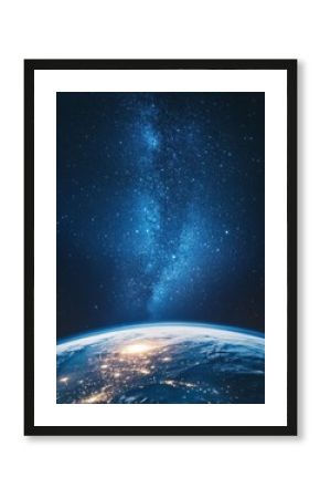 Earth view from space showing city lights and the Milky Way galaxy in the night sky above in a vertical shot