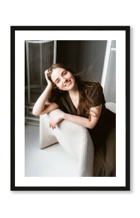 Woman relaxing in modern interior space with natural light