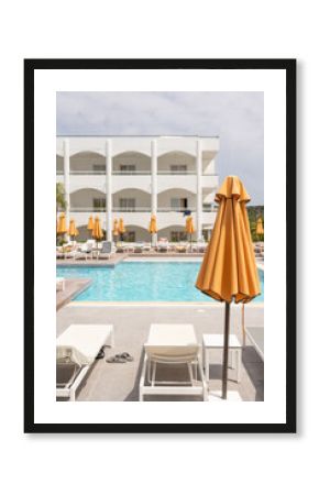 Resort Pool Area with Deck Chairs and Umbrellas 