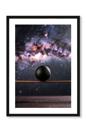A single dark oval object rests on a thin metallic line against a backdrop of a vibrant colorful nebula in deep space
