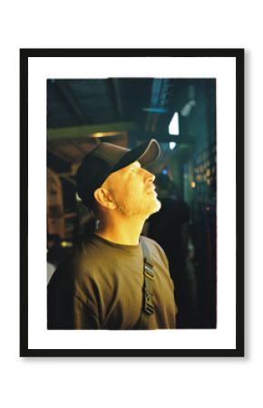 Man gazes upward in an illuminated space