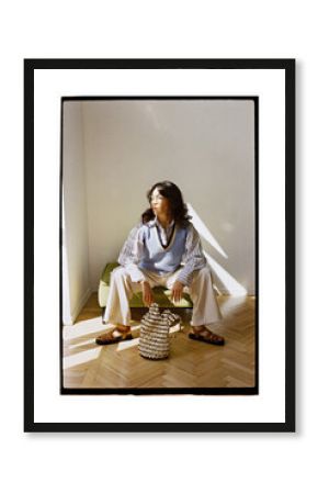 Modern woman poses in cozy indoor space