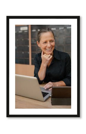 Smiling professional working on a laptop in a modern office space