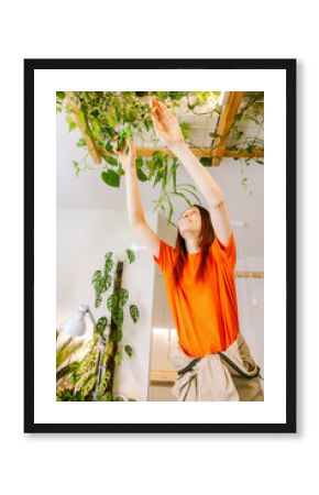 Woman caring for indoor plants in bright space
