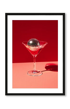 Cocktail party with disco ball on sunset coral color background. Disco party, retro fashion. Modern stylish banner template for holiday card, banner, flyer, menu with space for text