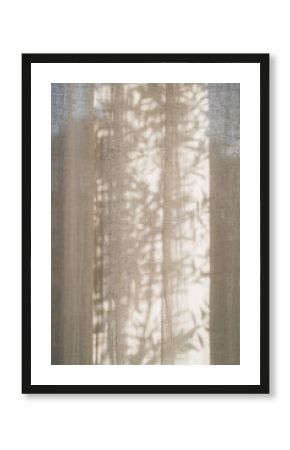Floral sunlight shadows on a neutral beige linen curtains, aesthetic minimalist natural background with copy space