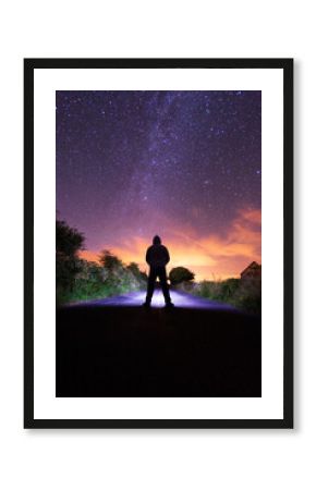 Silhouette of a man looking at the night sky.