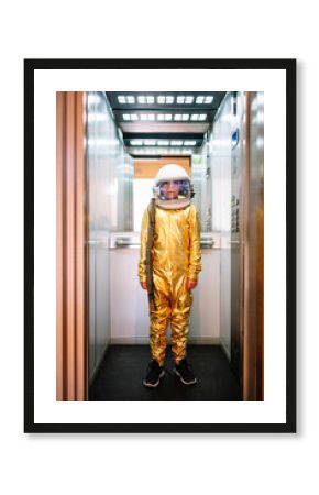 Boy wearing space suit standing in open elevator