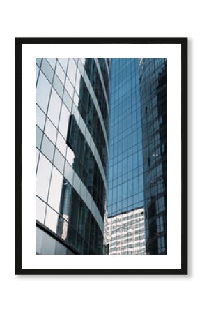 Urban glass towers in tight framing with reflections and curves, clean composition for financial architecture, business background and copy space