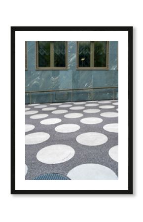 Circular pavement pattern on modern plaza surface, architectural design combining geometry, rhythm and functionality in contemporary urban public space