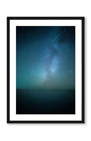 Night and beautiful landscape with a galaxy on the sky ,sand quarry at the night, cold and blue colors on picture.Trees stands on the sand , milky way on the background , night shot , Ukrainian nature