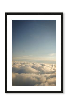 The endless horizon of the sky above the clouds. Great view from the plane window while traveling.