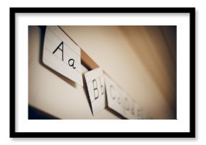 Low angle view of alphabets written on paper hanging in classroom