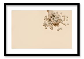 Top view of wooden hand with pile of alphabet letters on cubes scattered on beige background in studio