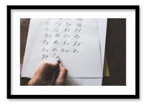 A Left Handed Person Writes The Alphabet With A Straight Calligraphy Pen